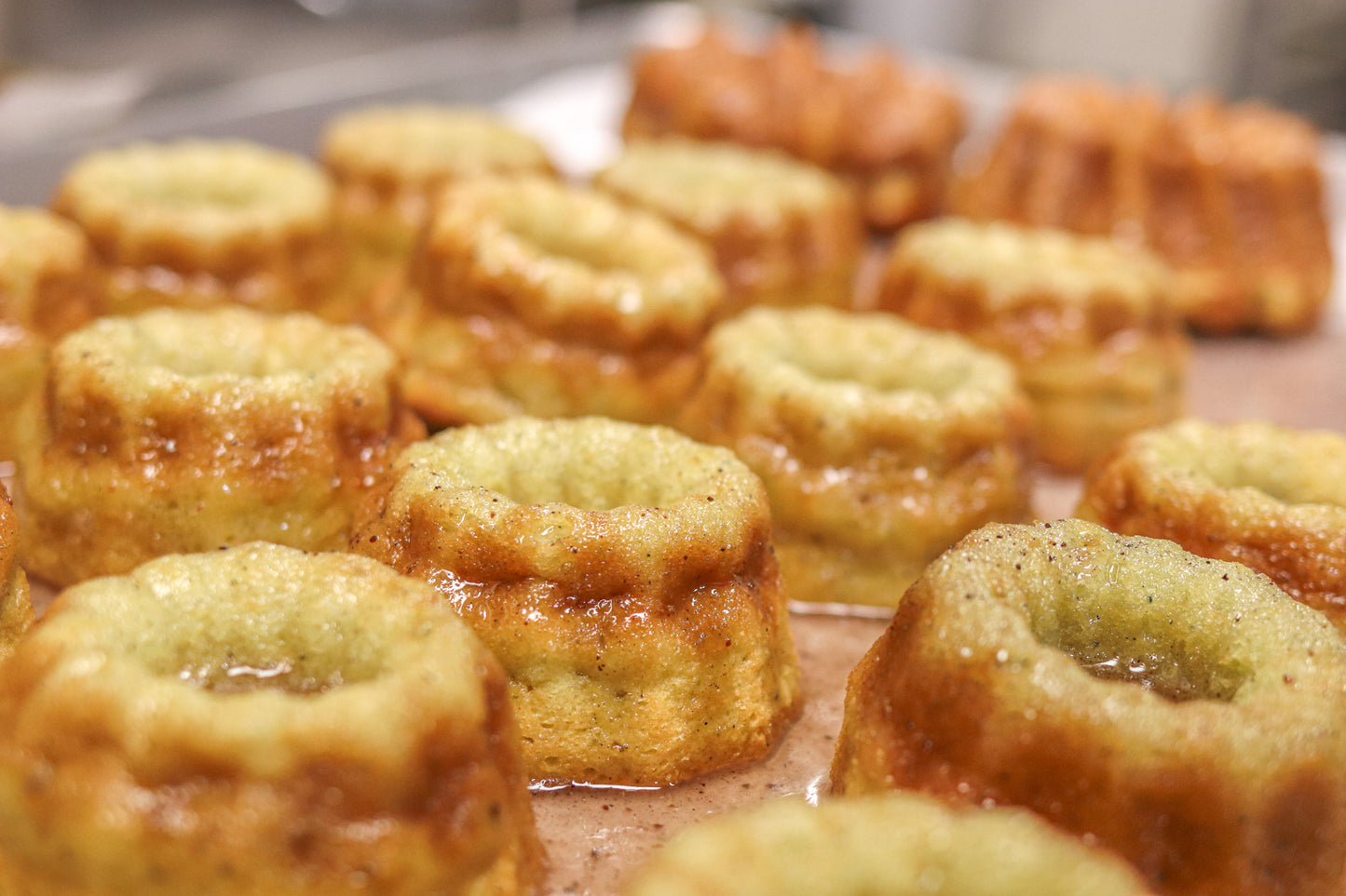 Small blueberry lemonade vodka cakes with a glaze finish on a plate